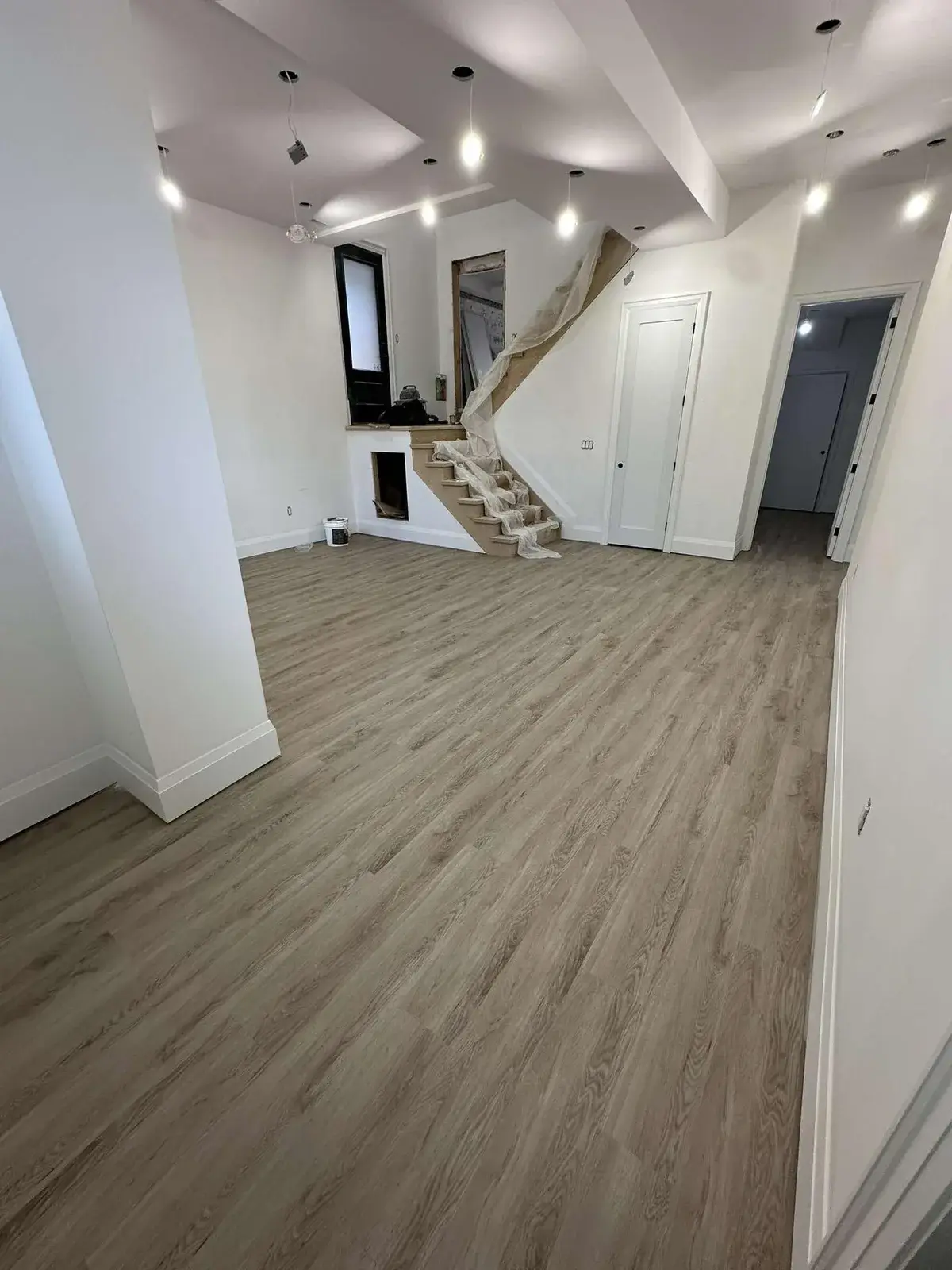 Vinyl plank flooring installed throughout a finished basement