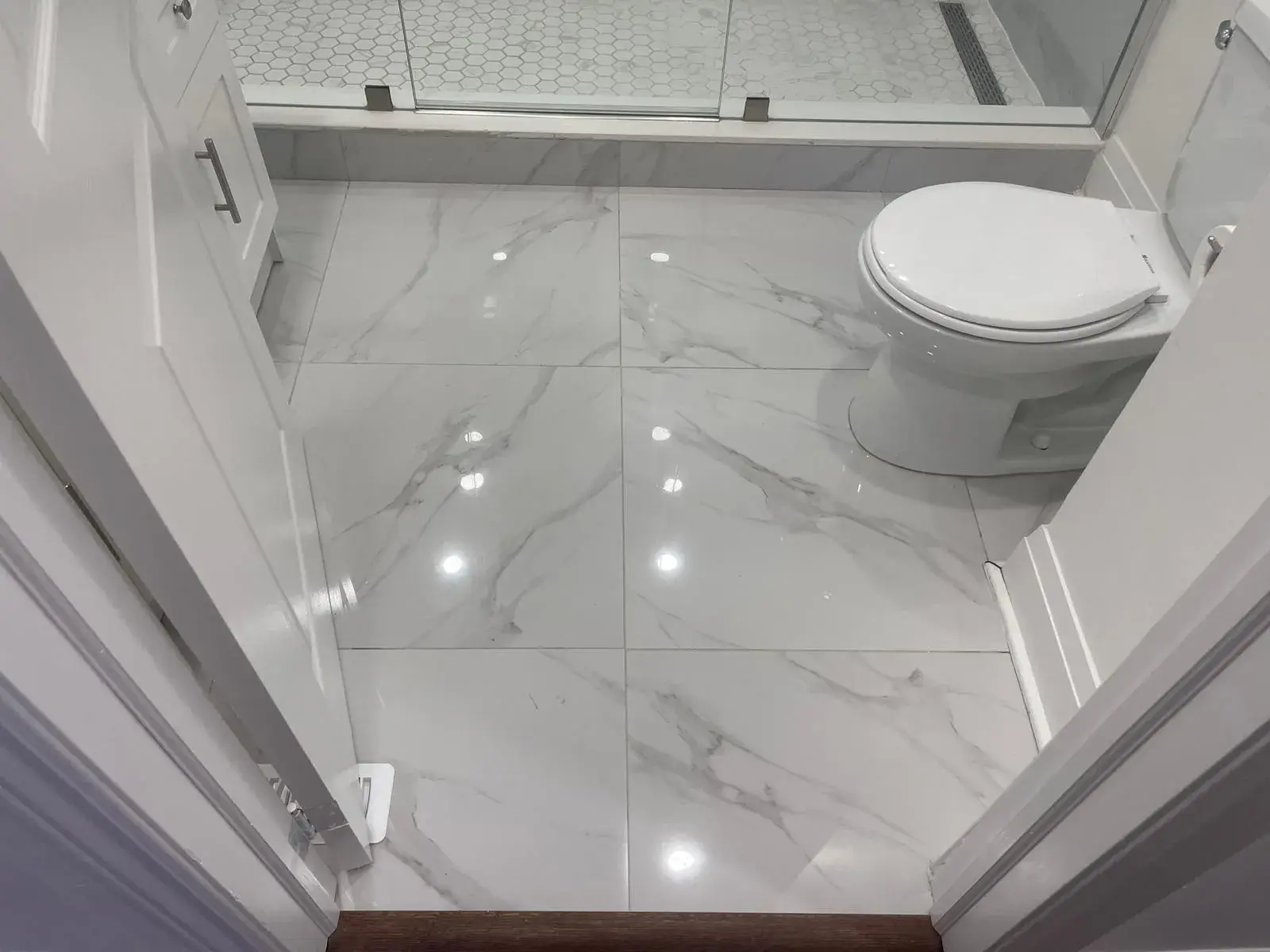 Large-format porcelain tile installed on a bathroom floor