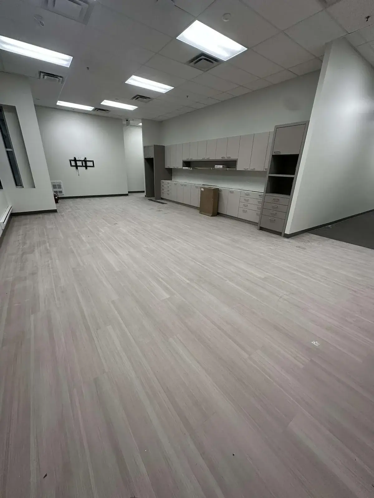 Grey vinyl plank flooring installed in a commercial office