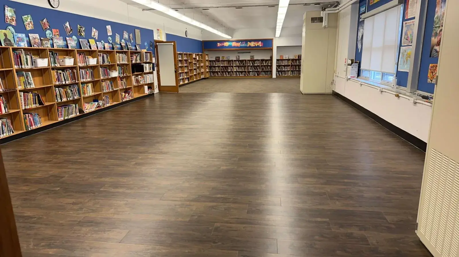 Dark vinyl plank flooring installed in a library