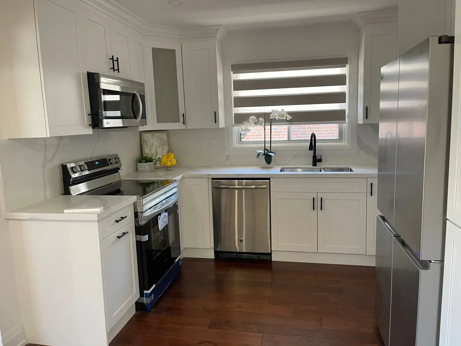 Renovated white shaker kitchen with stainless appliances