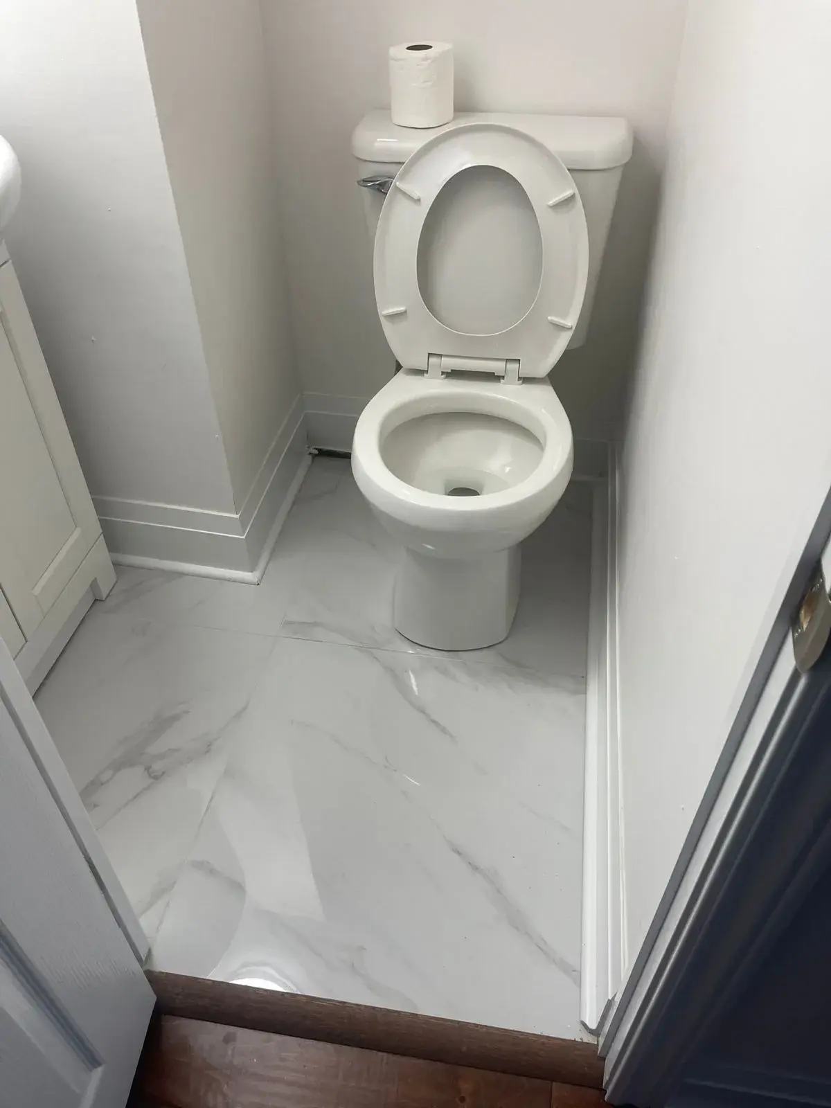 Powder room with a new porcelain tile floor